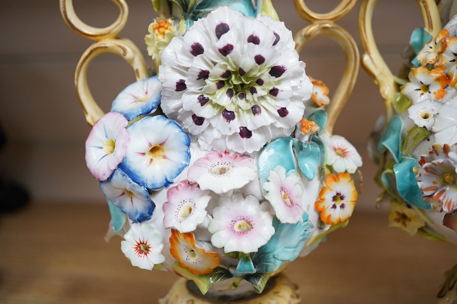 A Coalport garniture vase set with applied flowers, tallest 31cm. Condition - restored